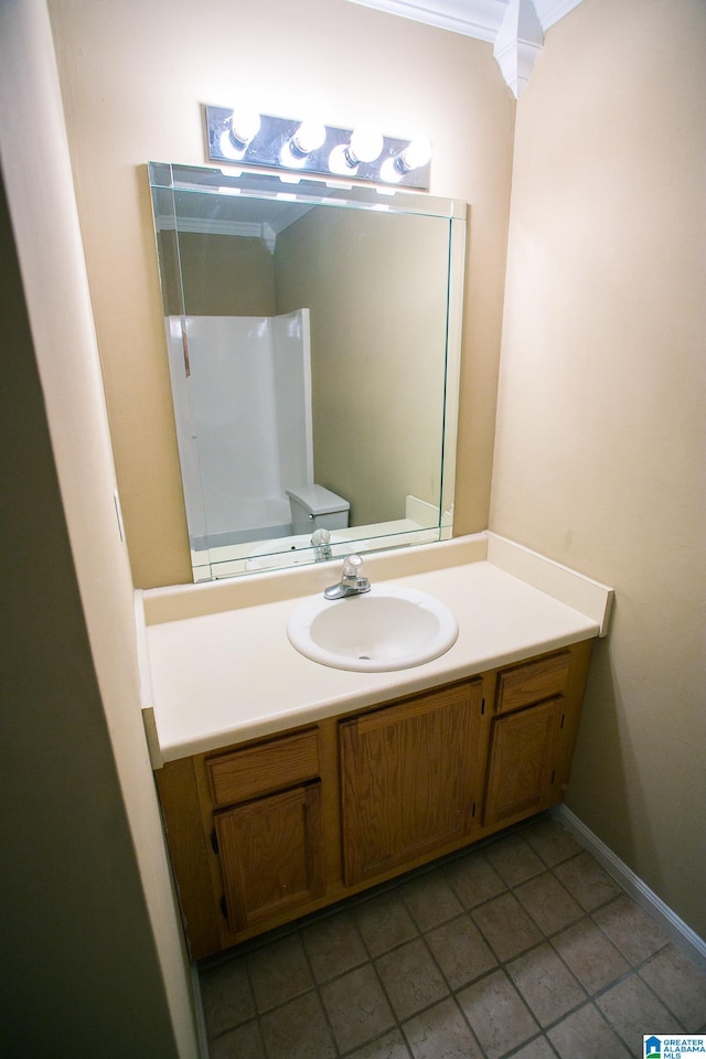 bathroom with crown molding, tile patterned flooring, vanity, and toilet