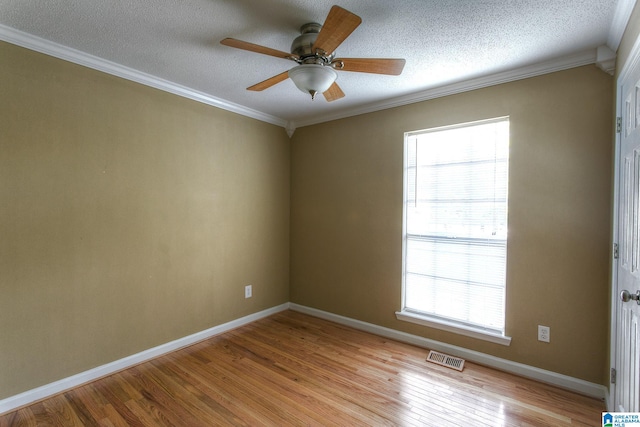 spare room with a textured ceiling, light hardwood / wood-style flooring, ceiling fan, and ornamental molding