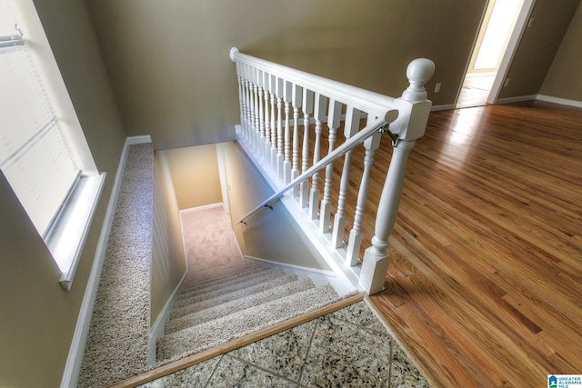 stairs featuring hardwood / wood-style flooring