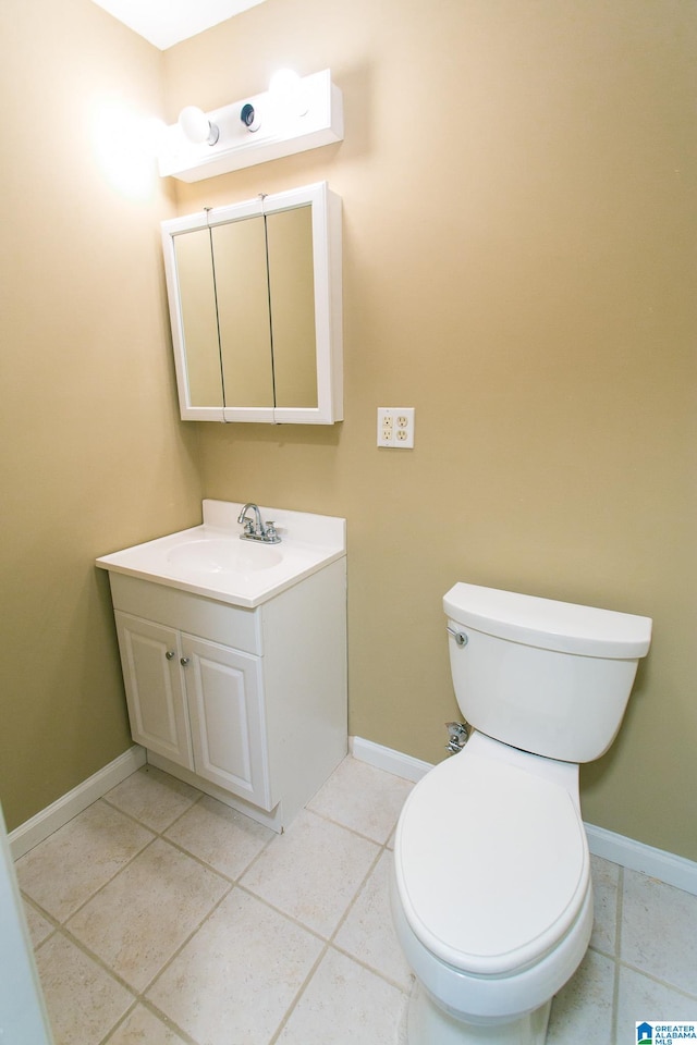 bathroom featuring tile patterned floors, vanity, and toilet