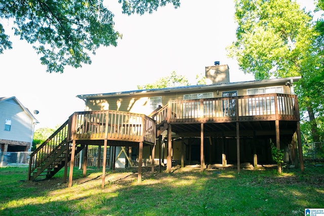 back of property with a lawn and a wooden deck