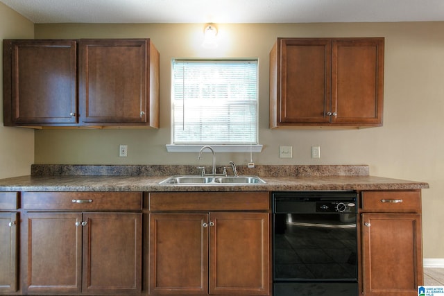 kitchen featuring tile patterned flooring, dishwasher, and sink