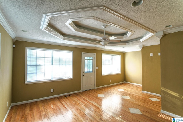 interior space with ceiling fan, light hardwood / wood-style floors, a textured ceiling, and ornamental molding