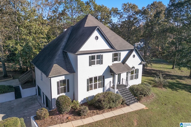 view of front of home with a front yard and a garage