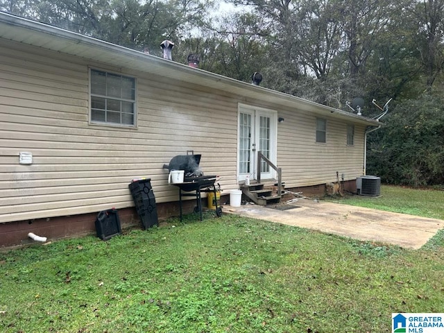 back of property featuring a lawn, a patio area, and cooling unit