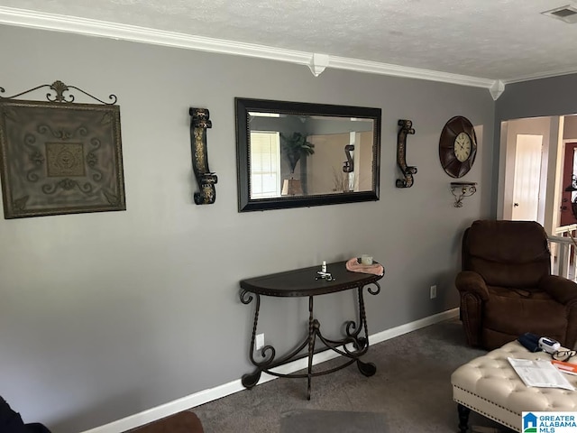 living area with a textured ceiling, dark carpet, and ornamental molding