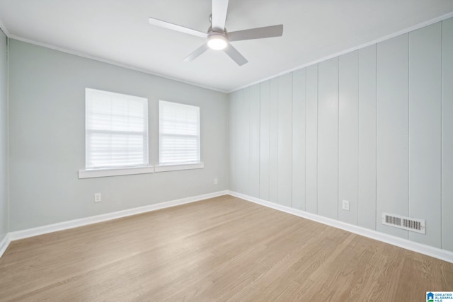 unfurnished room featuring ceiling fan, crown molding, and light wood-type flooring