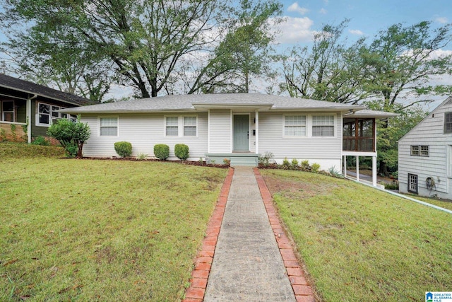 single story home with a sunroom and a front lawn