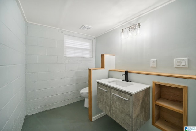 bathroom featuring vanity, concrete floors, and toilet