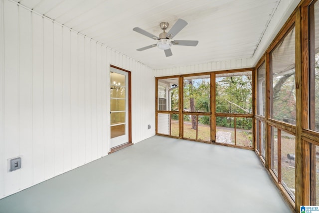 unfurnished sunroom featuring ceiling fan