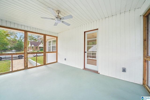 unfurnished sunroom featuring ceiling fan