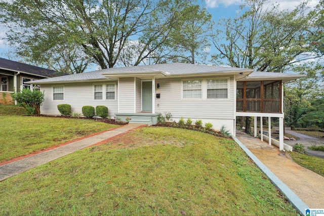 ranch-style house with a sunroom and a front yard