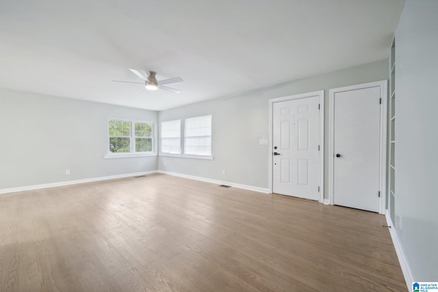 unfurnished room with ceiling fan and wood-type flooring