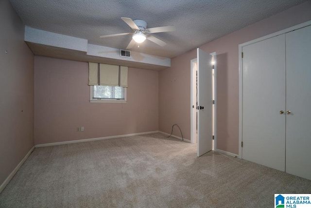 unfurnished bedroom featuring a textured ceiling, a closet, and ceiling fan