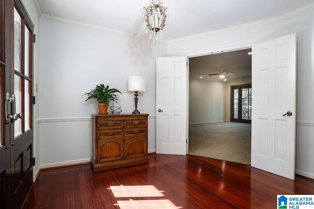 foyer featuring ceiling fan with notable chandelier, hardwood / wood-style flooring, and crown molding