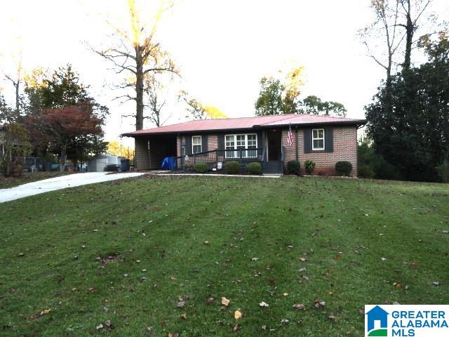 ranch-style house featuring a porch and a front lawn