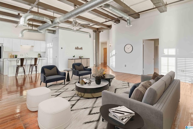 2301 1st Ave N Unit 203, Birmingham, AL 35203 - living area with a high ceiling, a ceiling fan, and light wood-type flooring