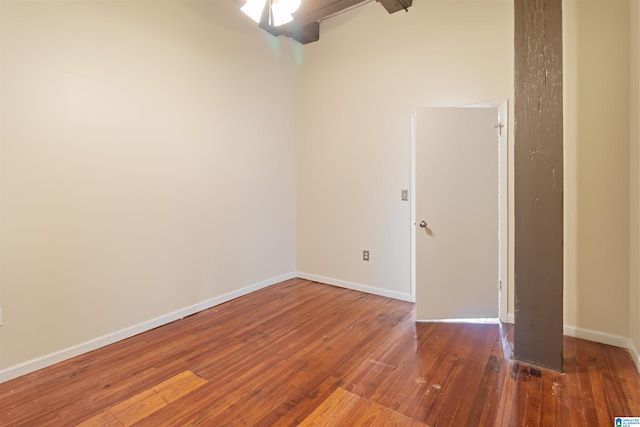 unfurnished room featuring dark hardwood / wood-style flooring