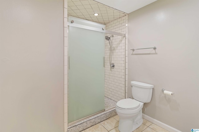 2301 1st Ave N Unit 203, Birmingham, AL 35203 - full bath featuring toilet, tile patterned flooring, a stall shower, and baseboards