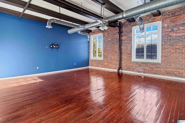 2301 1st Ave N Unit 203, Birmingham, AL 35203 - unfurnished room featuring baseboards, hardwood / wood-style floors, brick wall, and a ceiling fan