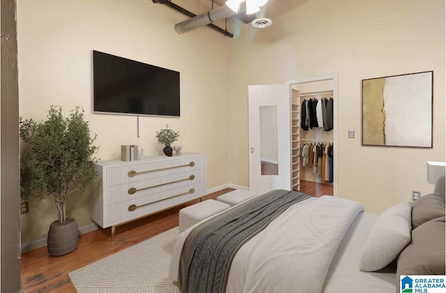 2301 1st Ave N Unit 203, Birmingham, AL 35203 - bedroom featuring wood finished floors, a spacious closet, baseboards, and a closet
