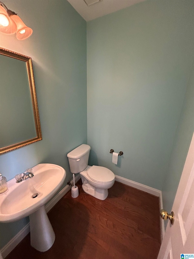 bathroom featuring hardwood / wood-style floors and toilet