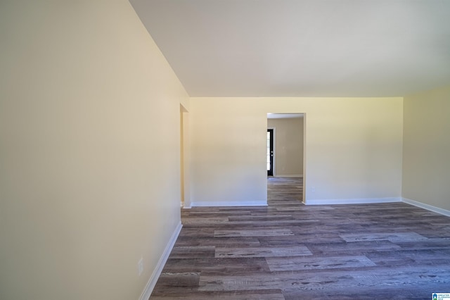 empty room with dark hardwood / wood-style flooring