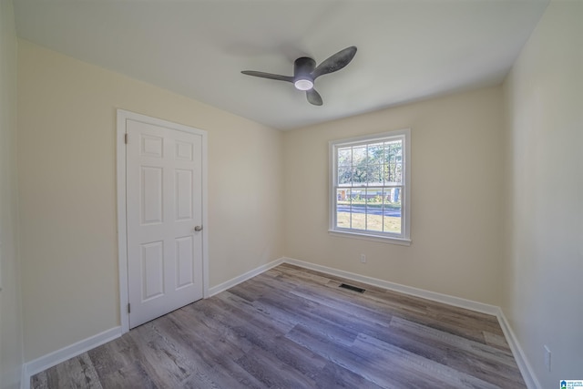 spare room featuring light hardwood / wood-style flooring and ceiling fan