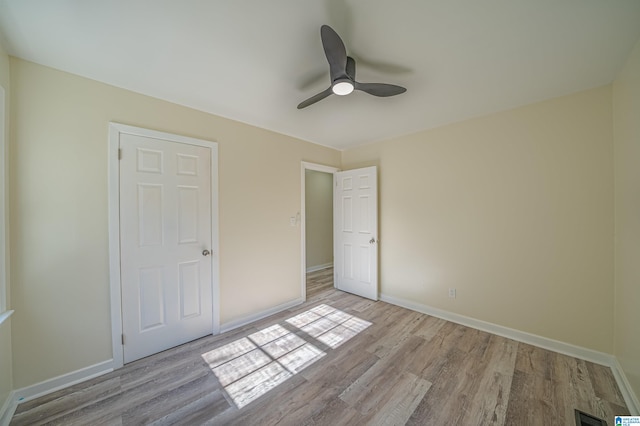 unfurnished bedroom featuring ceiling fan and light wood-type flooring