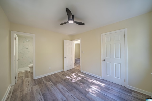 unfurnished bedroom with ensuite bathroom, ceiling fan, and light hardwood / wood-style floors