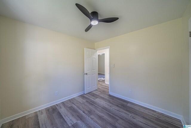 spare room with hardwood / wood-style flooring and ceiling fan