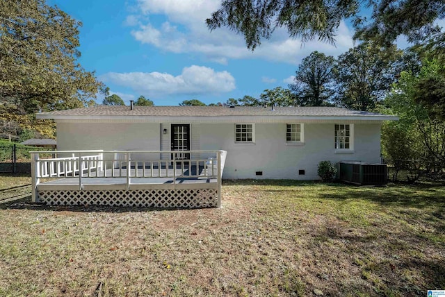 back of property with a wooden deck, central AC, and a lawn