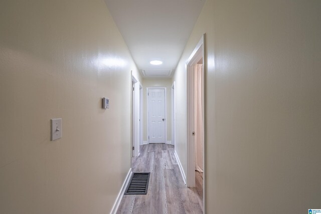 corridor with light hardwood / wood-style flooring