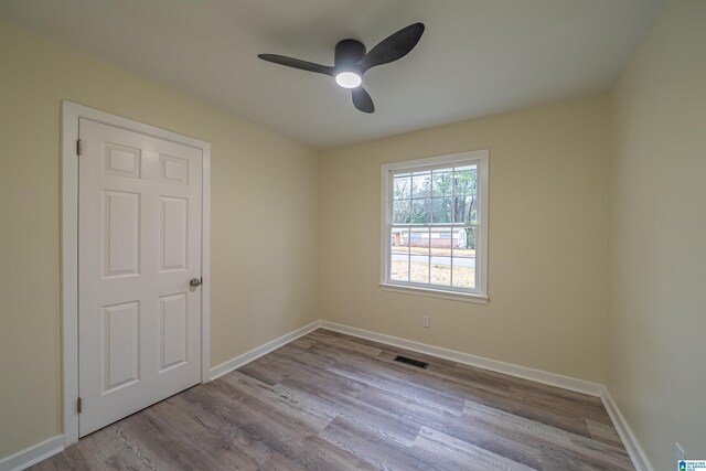 empty room with light hardwood / wood-style floors and ceiling fan