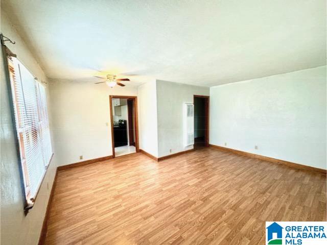 910 E 15th St, Anniston, AL 36207 - unfurnished room with light wood-style flooring, baseboards, and ceiling fan