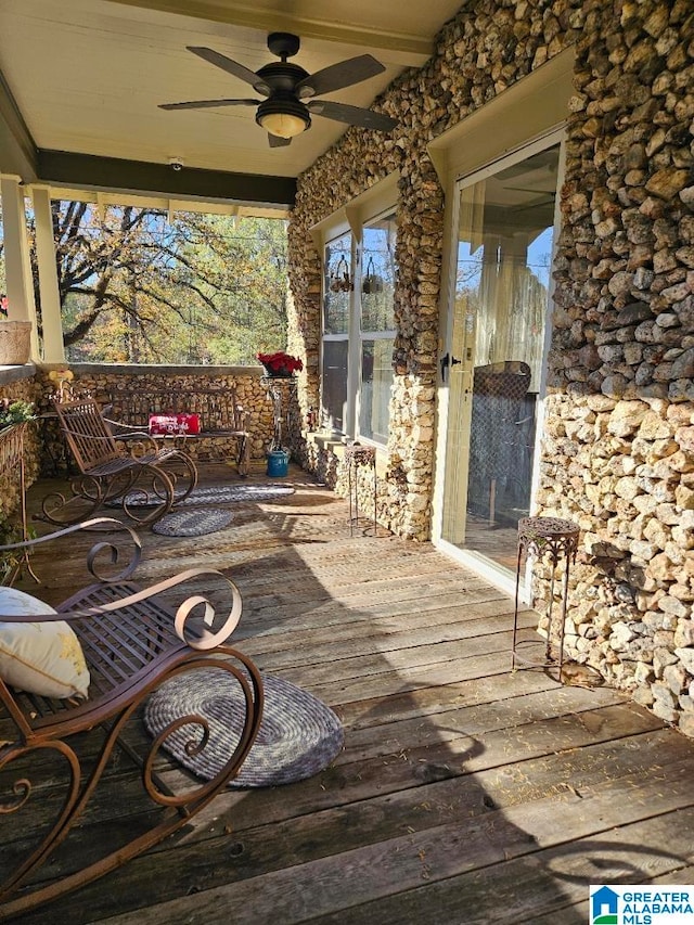 wooden terrace featuring ceiling fan