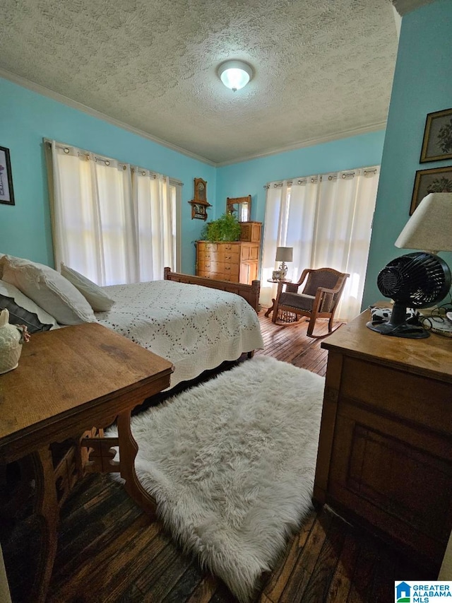 bedroom with dark hardwood / wood-style flooring and a textured ceiling