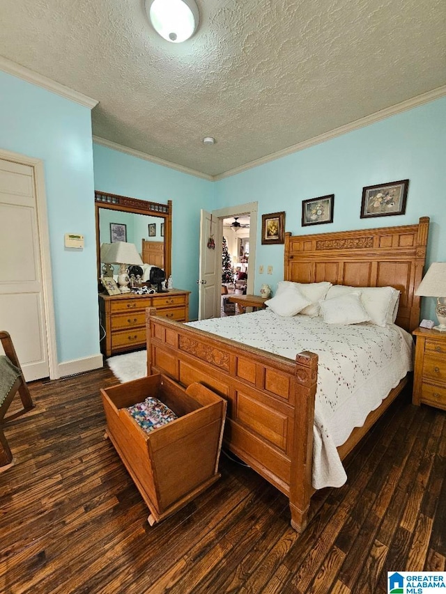 bedroom featuring dark hardwood / wood-style flooring, ornamental molding, and a textured ceiling