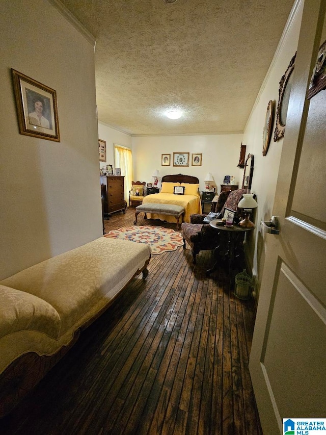 bedroom with hardwood / wood-style floors, a textured ceiling, and crown molding