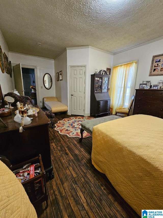 bedroom with a textured ceiling and dark wood-type flooring