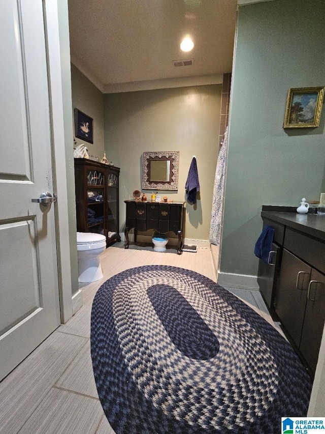 bathroom featuring tile patterned floors, vanity, and toilet