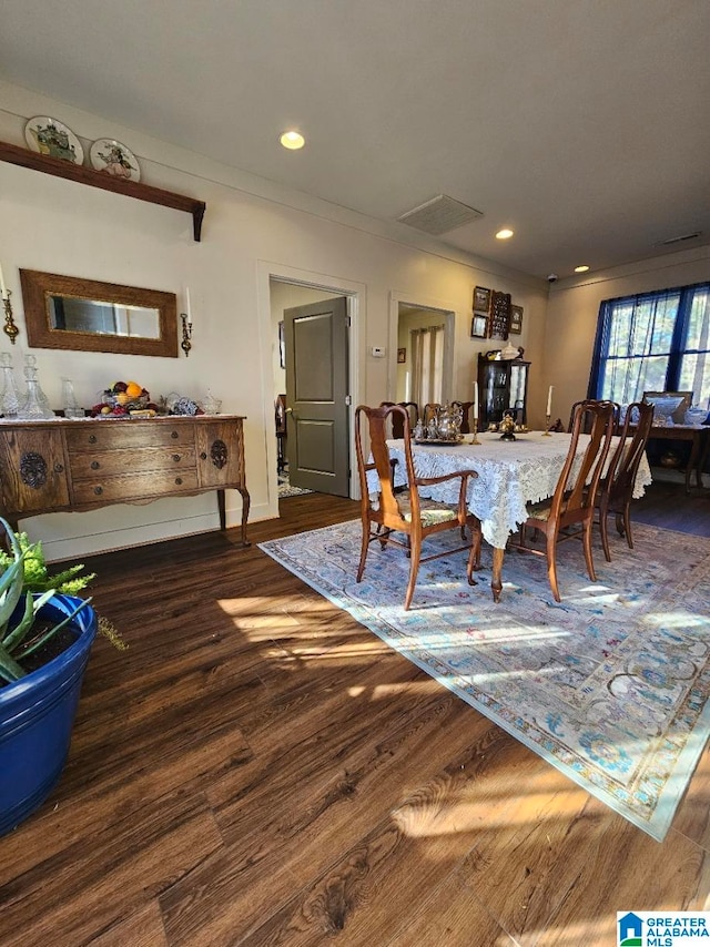 dining area with dark hardwood / wood-style flooring