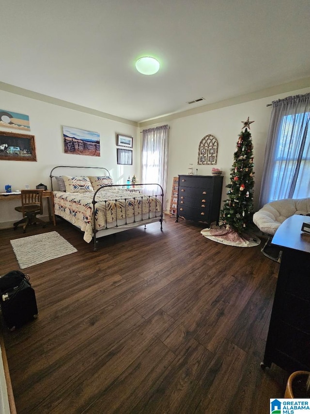 bedroom with dark wood-type flooring