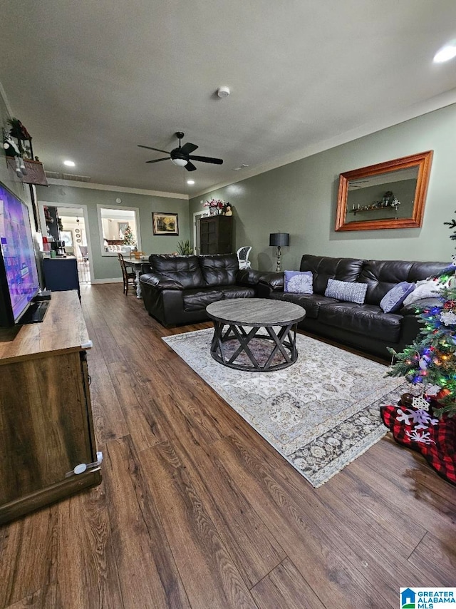 living room with wood-type flooring, a textured ceiling, ceiling fan, and crown molding