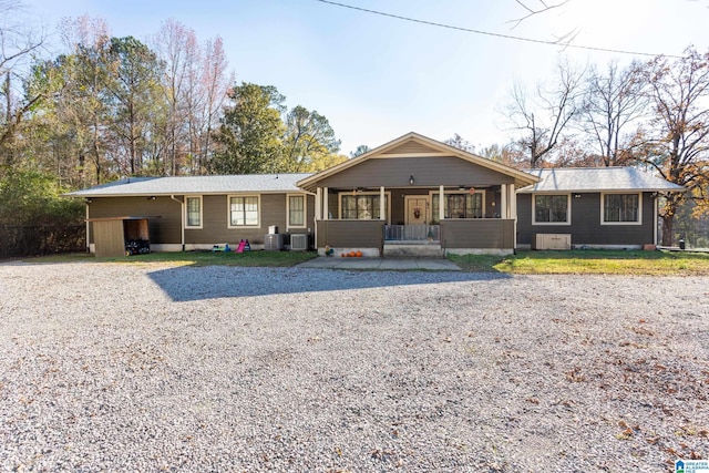 single story home featuring central air condition unit and a porch