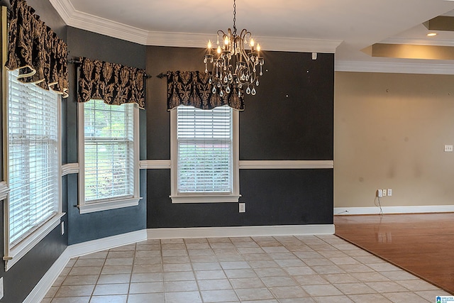 tiled empty room featuring a notable chandelier and ornamental molding