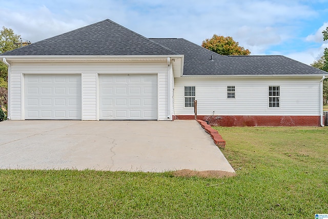 view of front of house with a garage and a front lawn