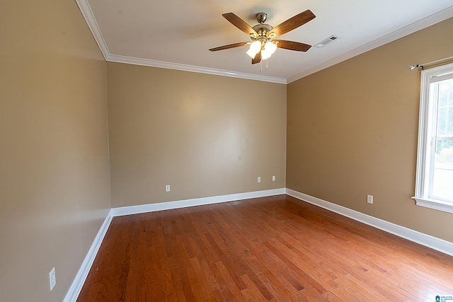 empty room featuring crown molding, hardwood / wood-style floors, and ceiling fan