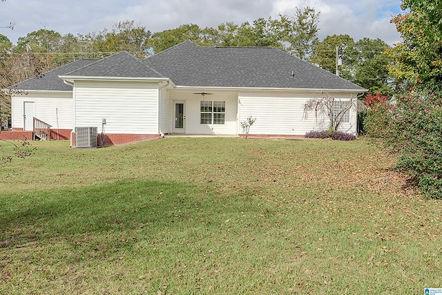 back of house featuring central AC, ceiling fan, and a yard