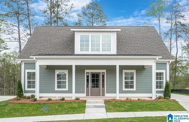 bungalow with a porch and a front yard